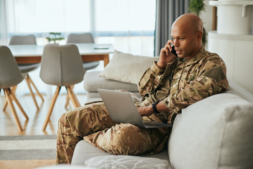 Young,African,American,Soldier,Communicating,Over,Cell,Phone,While,Surfing